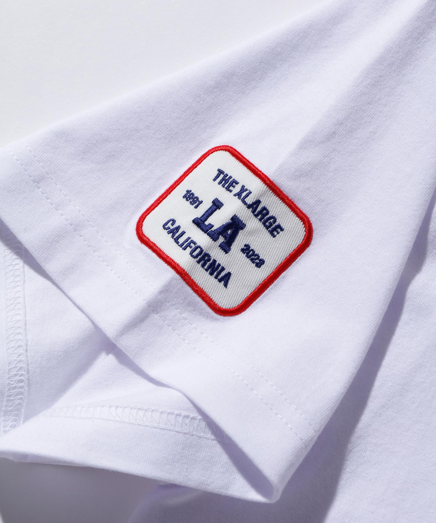 เสื้อยืดแขนสั้น XLARGE รุ่น Logo Patched S/S Pocket Tee